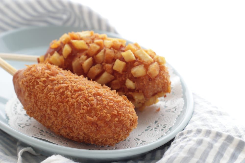 You'll find dishes like Korean corn dogs stuffed with hot dogs, cheese, potatoes, or other foods at your local Korean restaurant or food truck.

