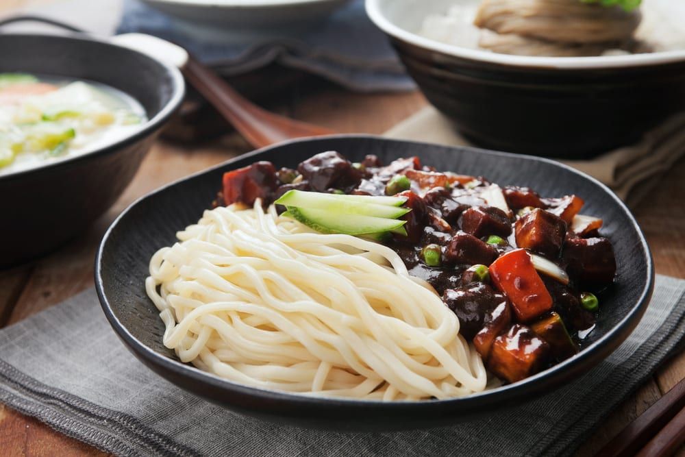 Dazzle your next meeting with Korean catering ideas like this one, noodles with black bean sauce. 