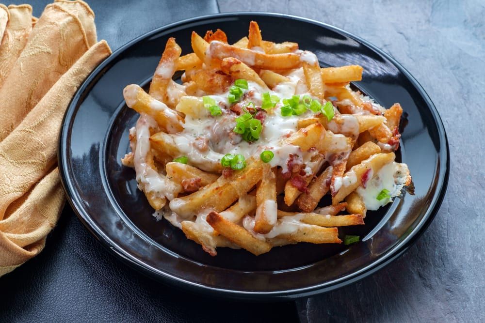 If you need creative catering ideas for a casual team lunch, try these fries loaded with kimchi and other Korean foods. 