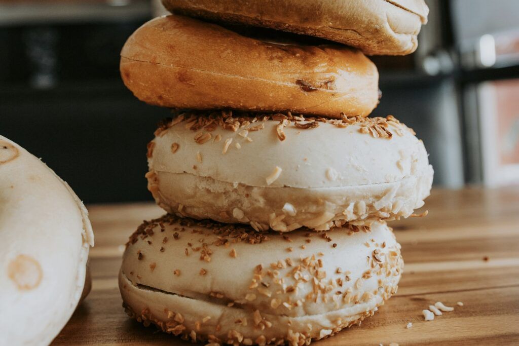 A stack of four assorted bagels.