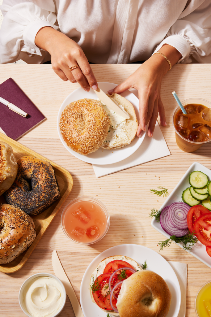 spreading cream cheese onto a bagel