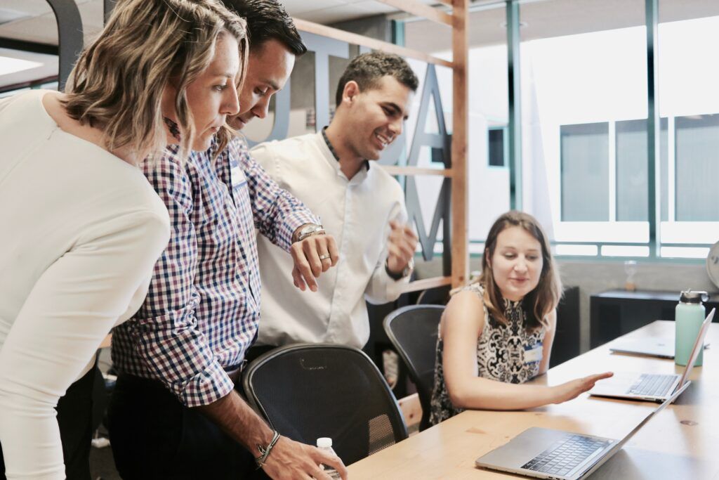 coworkers gathered around a desk