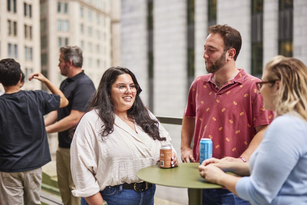 Coworkers talking around a table during their break.