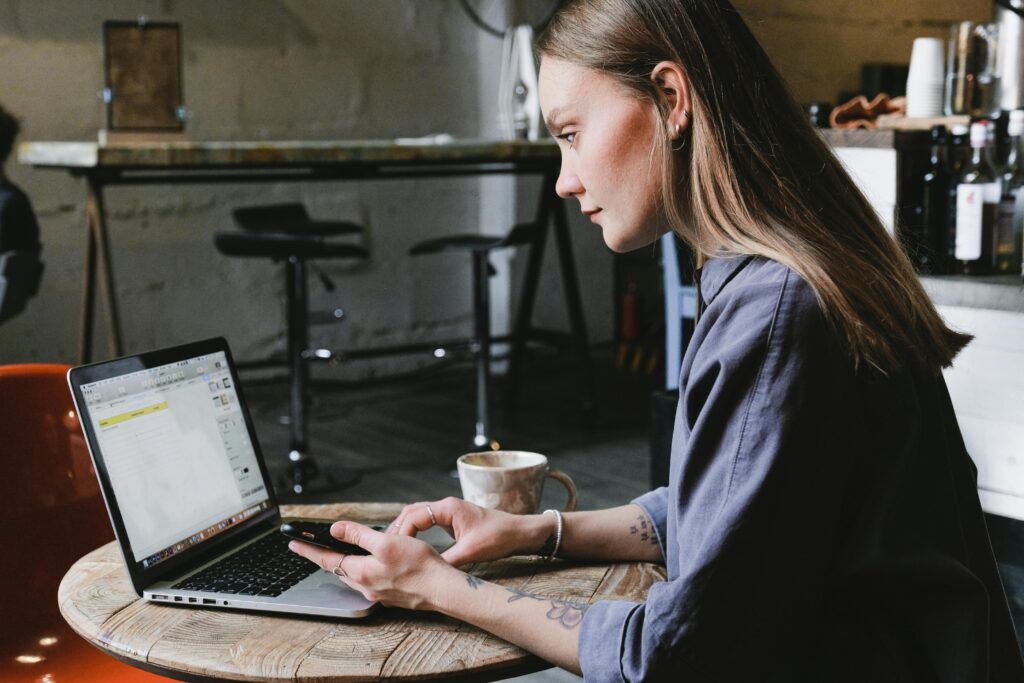 A woman typing on her computer. 