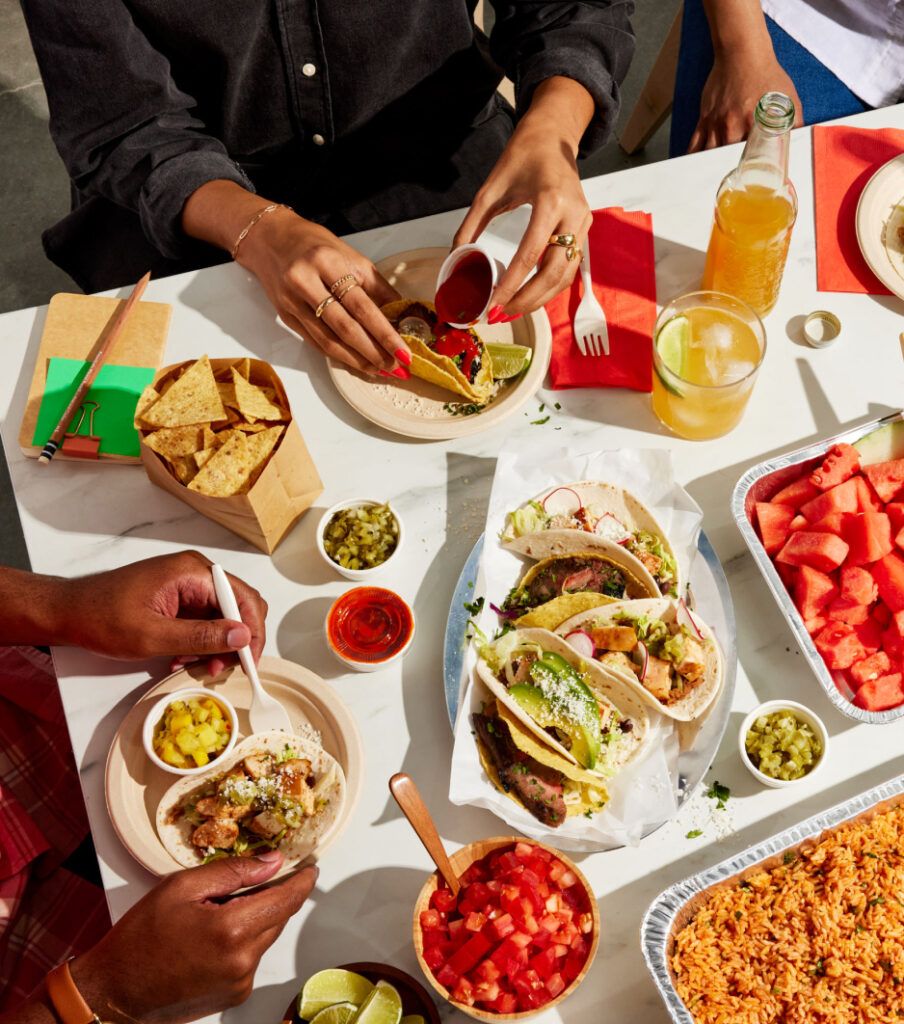 People eating a taco spread at work