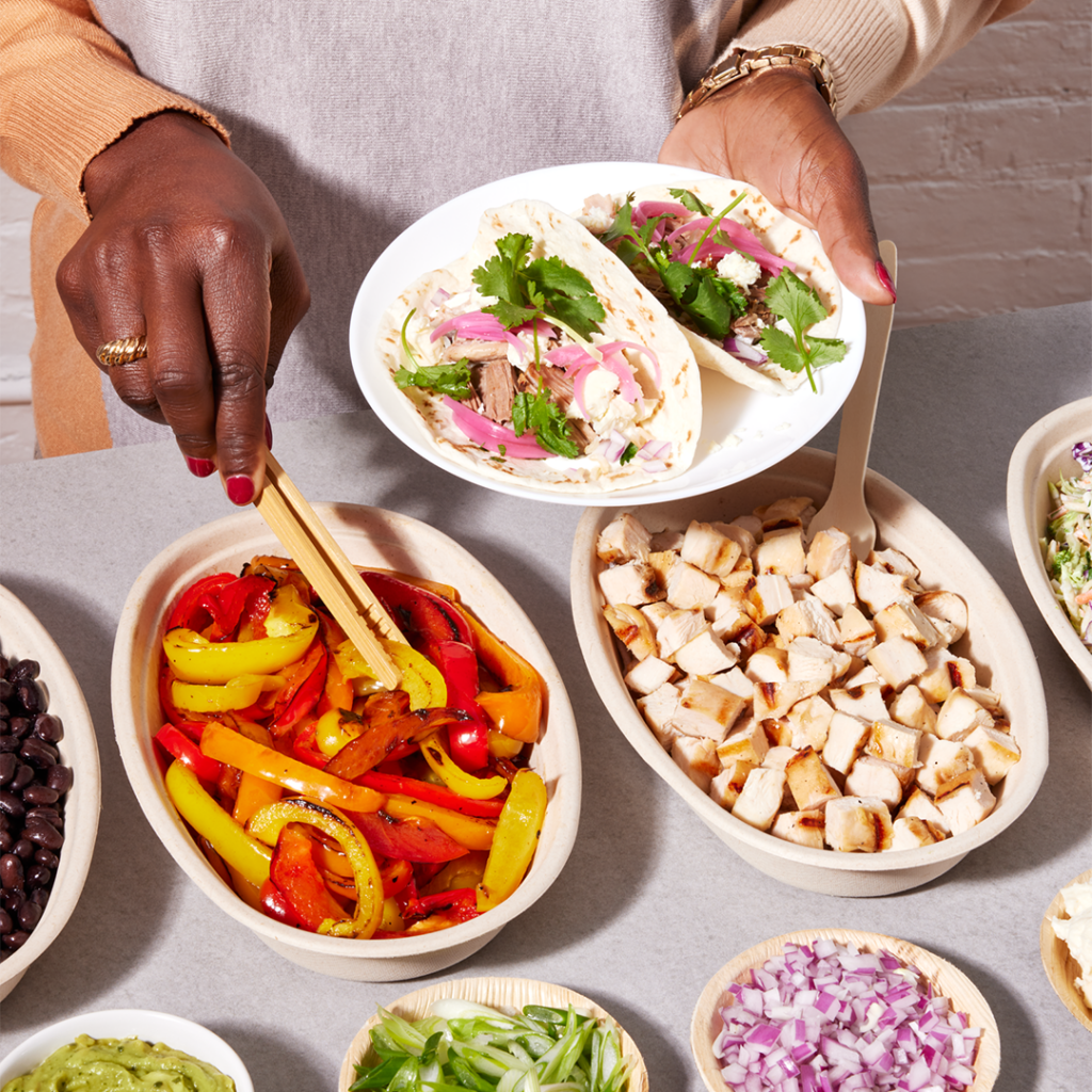 Person serving themselves from a catered taco bar