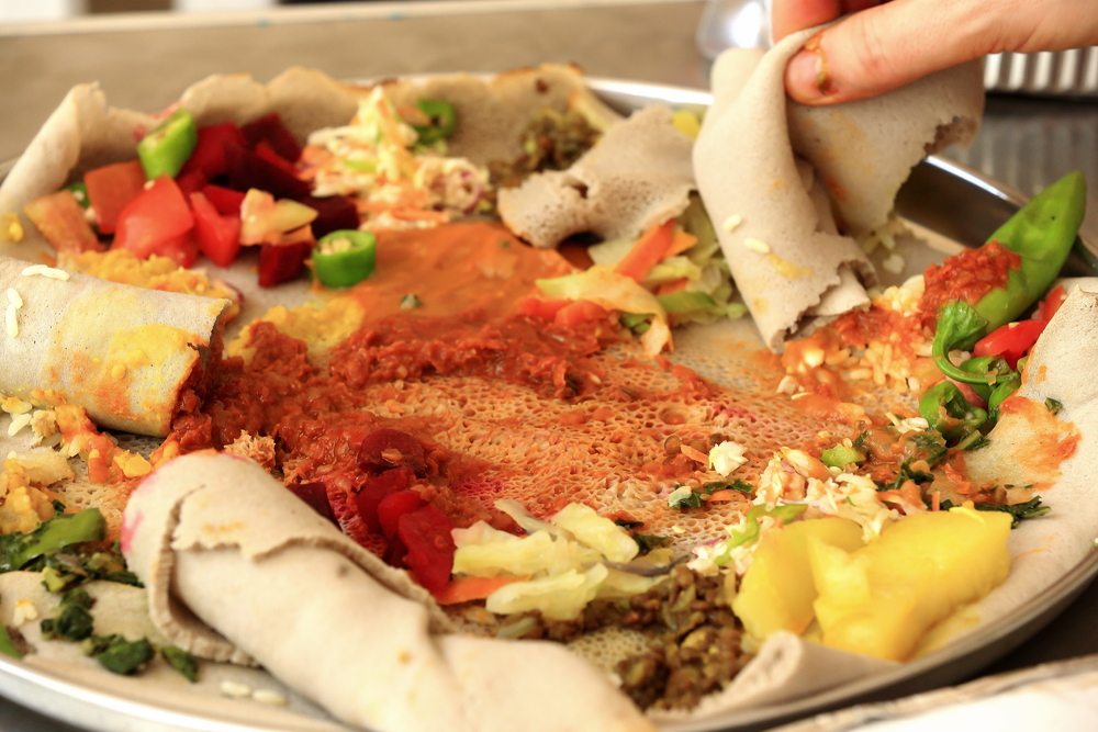 Ethiopian injera piled with stews and sauces.