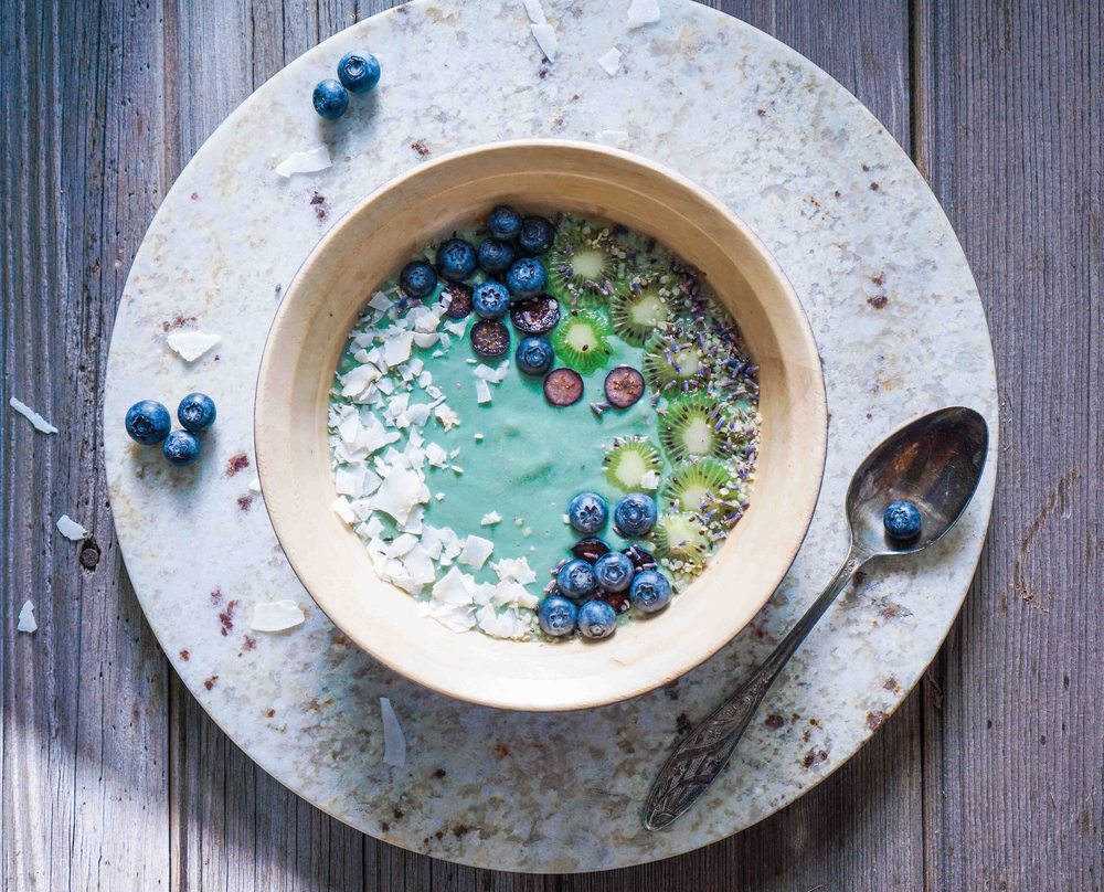 Breakfast bowl with spirulina, coconut, and blueberries.