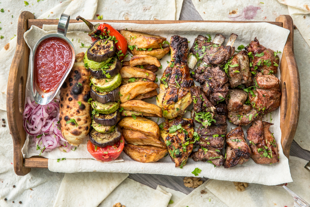 You might not be able to fly to Georgia, but you can definitely get a catering spread of traditional Georgian food delivered to your office.